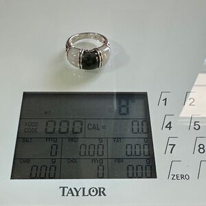 Silver sterling ring size 7 . White and green jade between silver bands.